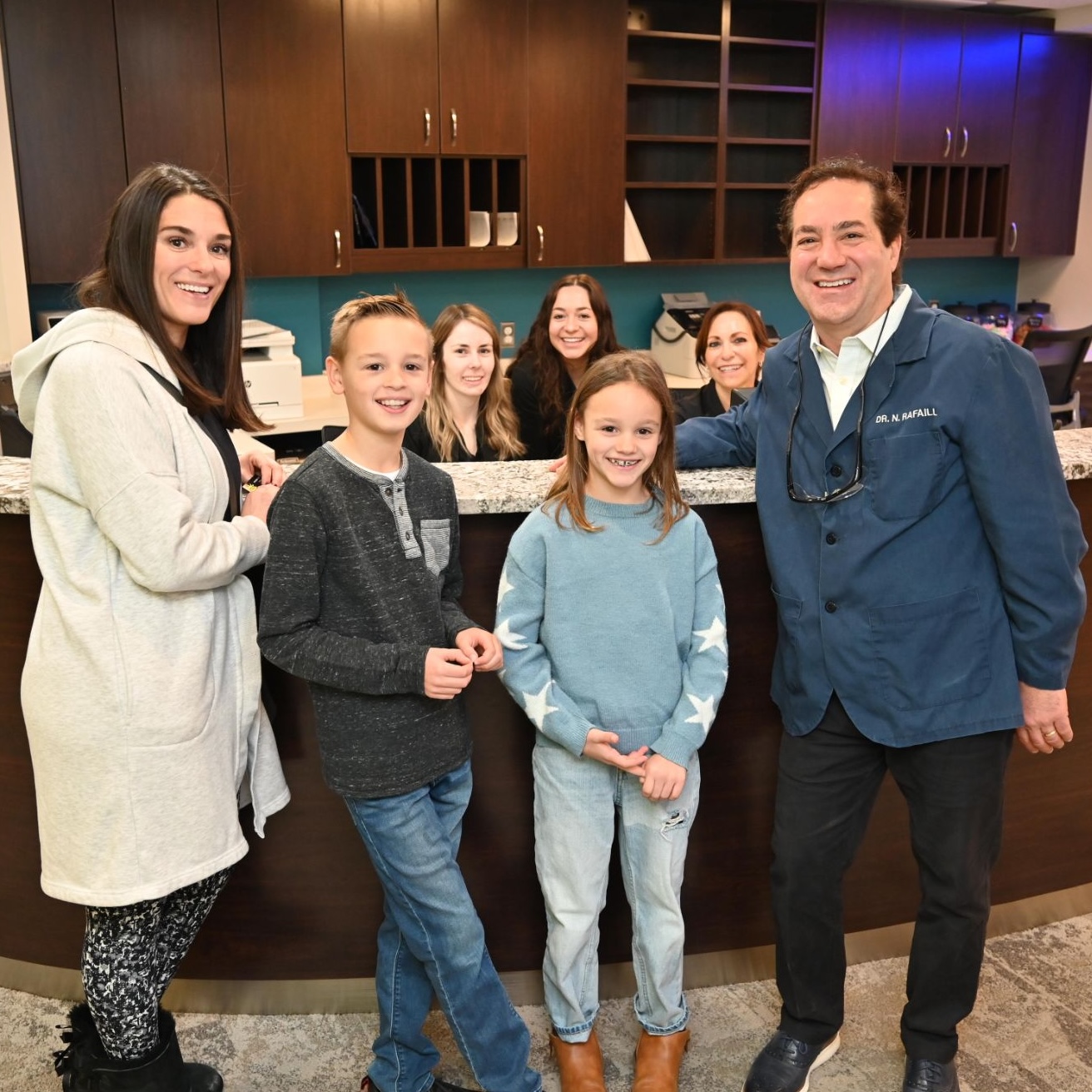 family at orthodontic appointment smiling