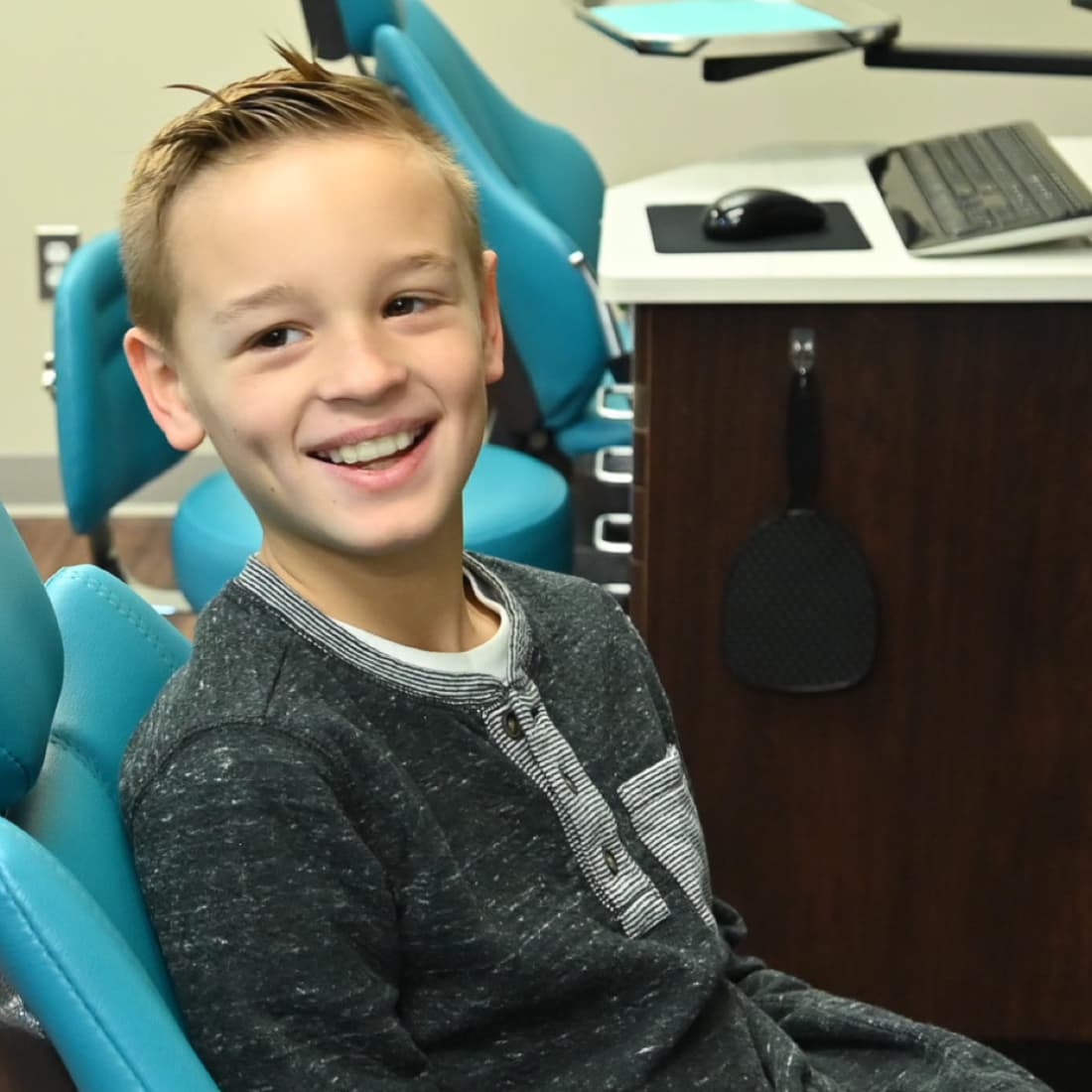 young boy with braces smiling